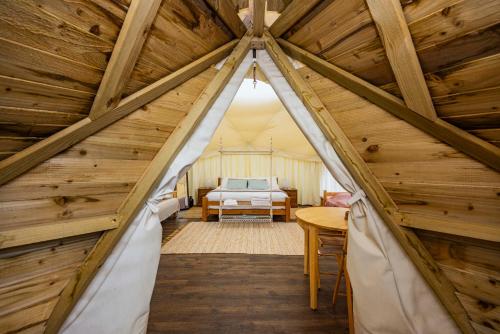 a attic room with a bed and a table at Meadow Vale Retreats in Screveton