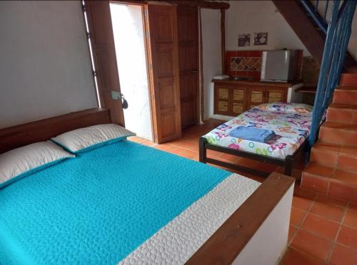 a small bedroom with a bed and a window at San Rafael del Campo - Barichara in Barichara
