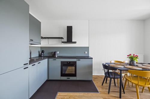 a kitchen and dining room with a table and chairs at Symphony Baltica Towers Apartamenty in Gdańsk