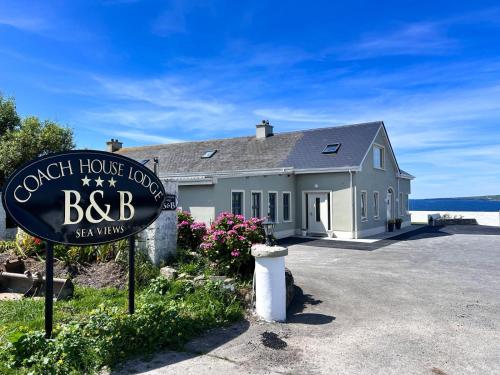 a bbb sign in front of a house at Coach House Lodge in Lahinch