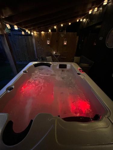 a bath tub filled with red water in a room at Heikant Hoeve met Jacuzzi in Baarle-Nassau