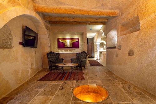 a hallway of a house with a table and chairs at Lagoon Cave Suites in Urgup