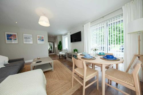 a living room with a table and a couch at Stunning and modern 2 bedroom apartment in Lucan in Lucan