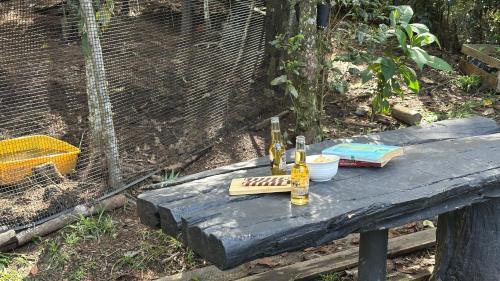 a table with two bottles on top of a bird cage at Casa Tikkun in Medellín