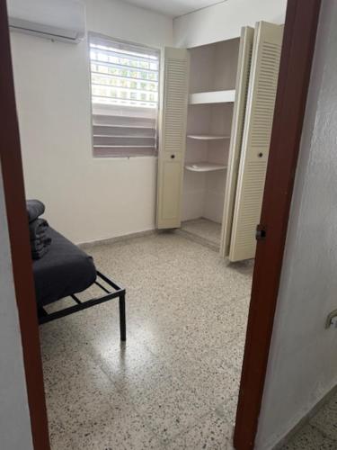 an empty room with a chair and a closet at Escape to Calm Quiet Bliss in Humacao