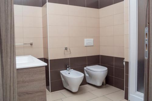 a bathroom with a toilet and a sink at Holiday Affittacamere in Corigliano Calabro