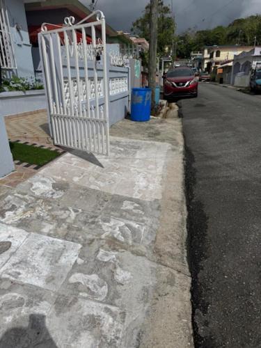 a white gate on the side of a street at Escape to Calm Quiet Bliss in Humacao