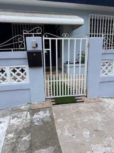 a blue house with a gate in front of it at Escape to Calm Quiet Bliss in Humacao