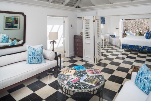 a living room with a couch and a table at Round Hill Hotel & Villas in Montego Bay