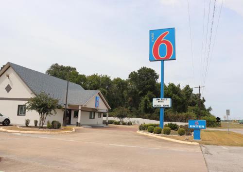 a speed limit sign in front of a gas station at Motel 6-Alvin, TX in Alvin