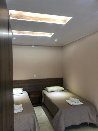 a bedroom with two beds and a skylight at Villa MaryElen Marathias beach in Corfu Town