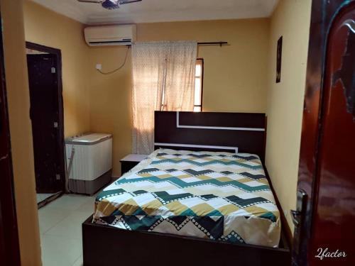 a bedroom with a bed in a room with a window at Apartment By Camp in Pakuro