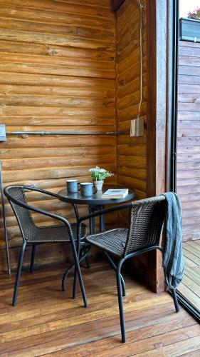 a table and two chairs on a porch at Casa Tikkun in Medellín