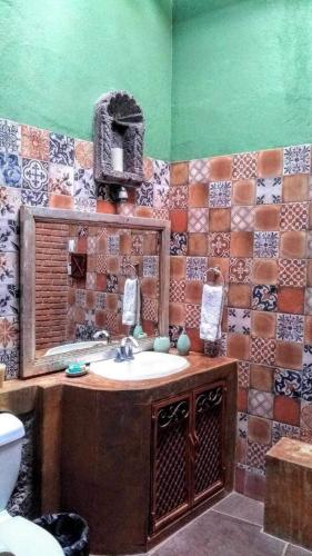 a bathroom with a sink and a mirror at Casona María Esther in San Miguel de Allende