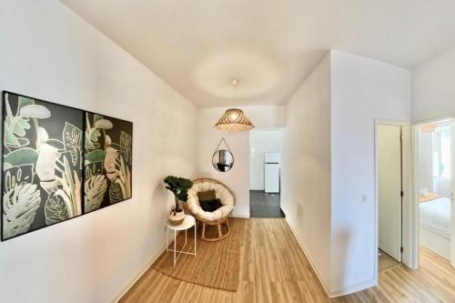 a living room with white walls and a ceiling at Madeira Breeze in Funchal