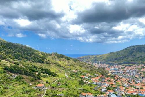 a view of a town on a hill at Sal e Pimenta House - A Wellbeing Retreat in Machico
