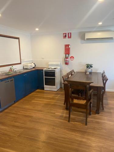 a kitchen with a table and a table and chairs at BeachBreaksManyana in Manyana