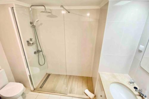 a bathroom with a shower and a toilet and a sink at Mar Sereno Praia Formosa in Funchal