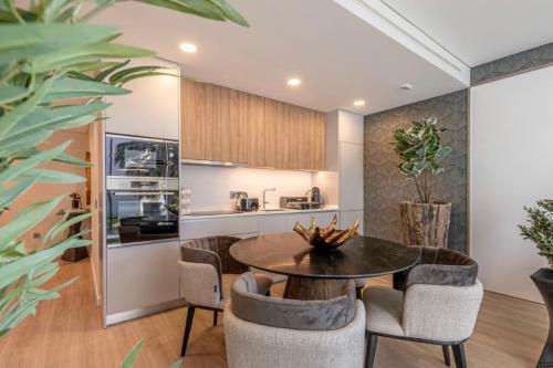 a kitchen and dining room with a table and chairs at Infinity Haven in Funchal
