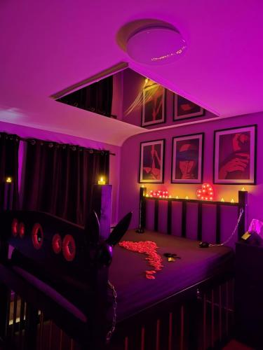 a purple room with a bed with a purple ceiling at Loveroom Eclat d emoi in Condé-sur-Noireau