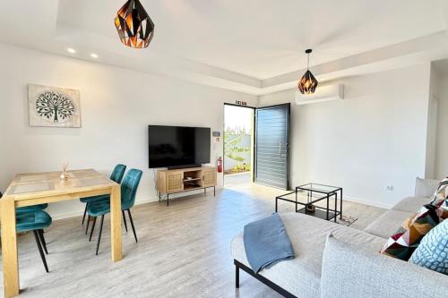 a living room with a table and a couch at Anna-Marie House in Ponta do Sol