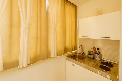 a small kitchen with a sink and a window at Apartments Nikola in Gradac