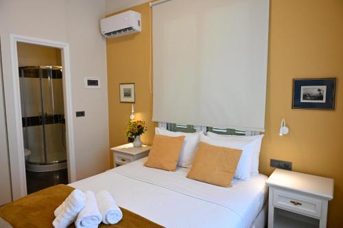 a bedroom with a bed with two towels on it at Porto Nafplio in Nafplio
