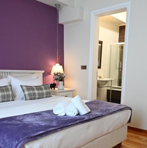 a bedroom with a bed with two towels on it at Porto Nafplio in Nafplio