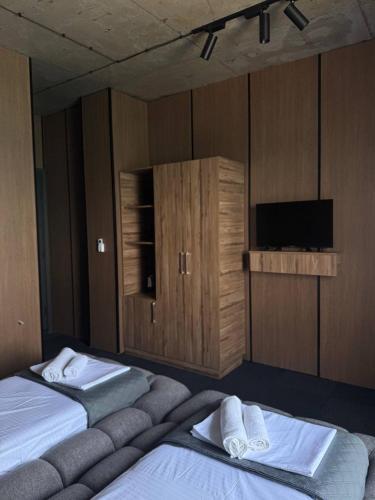 a hotel room with two beds and a television at Hotel black sea in K'obulet'i