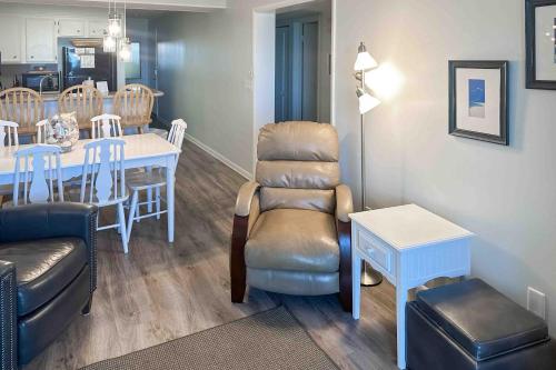 a living room with a chair and a table at Dunescape Villas 252 in Atlantic Beach