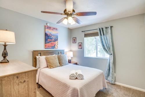 a bedroom with a bed with a ceiling fan at Bear Canyon Casa - Tucson Home Base with Mtn Views in Tucson