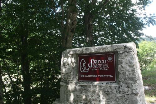 a sign for a park with trees in the background at Dimora del Capriolo in San Donato Val di Comino
