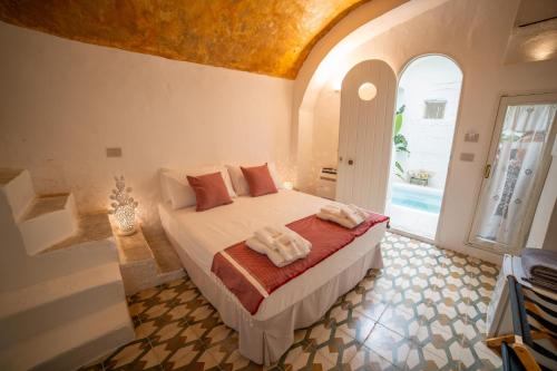 a bedroom with a bed with towels on it at Fundacari B&b in Gallipoli