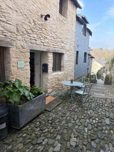 a stone building with a table in front of it at Merchants House in Penryn