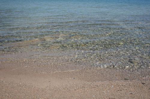 a beach with the sand and the water at Chalkida Apartments in Chalkida