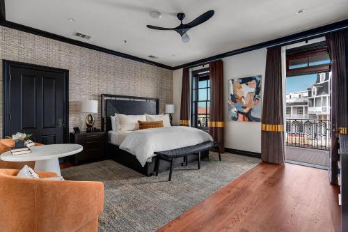a bedroom with a bed and a table and a couch at Emigrant Boutique Hotel in Fredericksburg