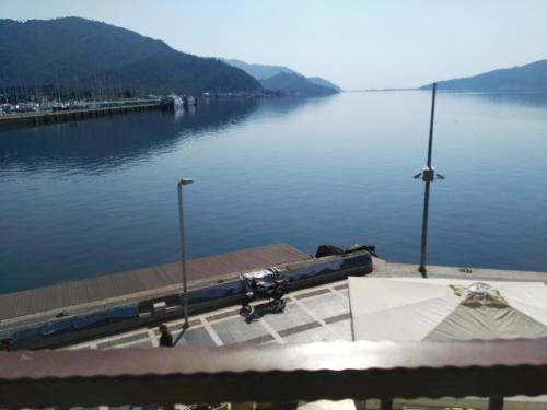 a dock on a body of water with a boat at Uysal Suite Seaside in Marmaris