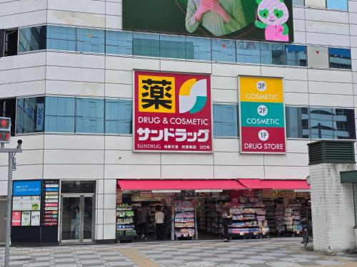 a building with signs on the side of it at SLEEPLAB THE STAY 池袋 -Ikebukuro- in Tokyo