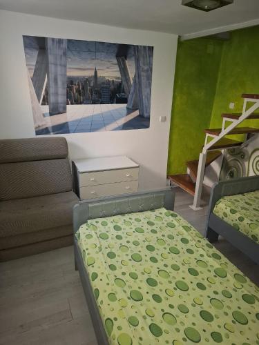 a living room with a bed and a couch at Apartmani Pelivan in Soko Banja