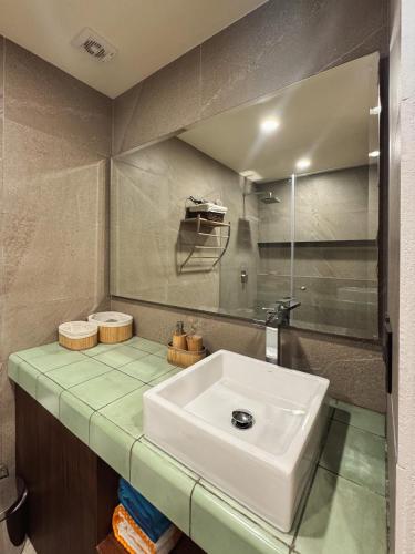 a bathroom with a sink and a mirror at Golden Hour 2BR Ocean View Apt in Holbox Island