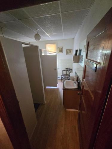a small bathroom with a sink and a mirror at Coal Branch Hotel & Restaurant in Coalspur