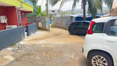 a white truck parked in front of a house at Chez Misto in Ouangani