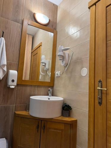 a bathroom with a sink and a mirror at Princess Nina Kolašin in Kolašin