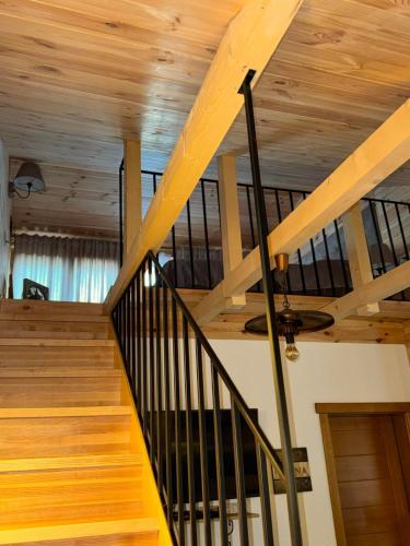 a staircase in a house with a wooden ceiling at Princess Nina Kolašin in Kolašin