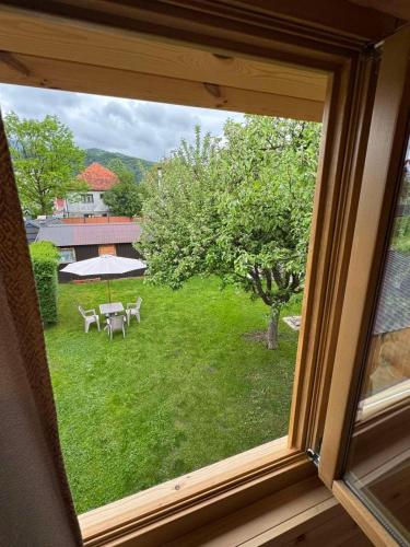 a window view of a yard with a table and chairs at Princess Nina Kolašin in Kolašin