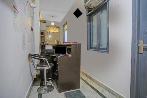 an office with a desk and a chair in a room at Hotel O The Premium Villa in New Delhi