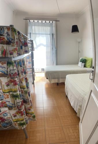 a bedroom with two beds and a curtain in it at Peniche Hostel in Peniche