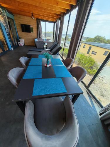 a conference room with a long table and chairs at Sea view BluEscape by Vellaris, Luxury Mobile Home in Mali Lošinj