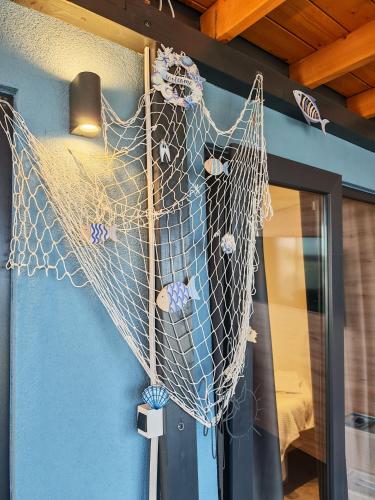 a net hanging on the door of a room at Sea view BluEscape by Vellaris, Luxury Mobile Home in Mali Lošinj