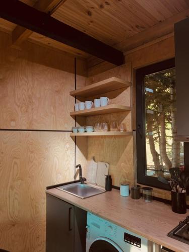 a kitchen with a sink and a counter with a window at Bakhmaro Green Horizon in Bakhmaro
